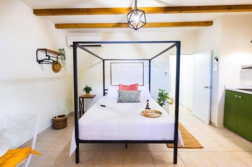 a bedroom with a canopy bed in a room at Catania 2 Suite W/private pool,W/heater , WIFI. in Aguadilla