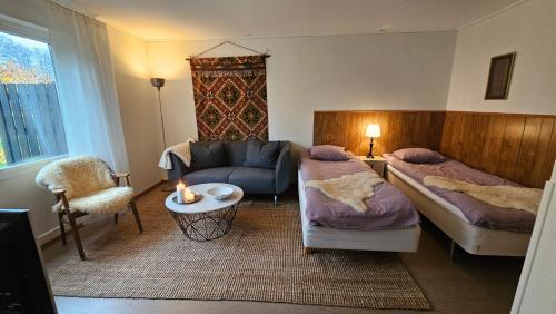 a living room with two beds and a couch at Åvillan - River house in Lagan