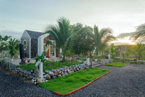 a house with a garden in front of a house at Cana Garden House 2 in Ban Khok