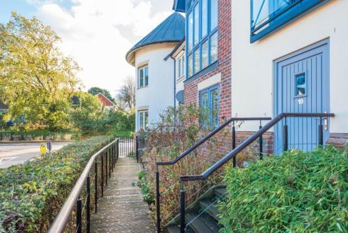 a stairway leading up to a house with a building at Sail Away in Lymington