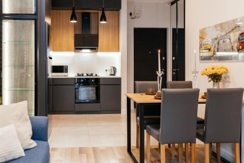 a kitchen and dining room with a table and chairs at K&J Loft in Tbilisi City