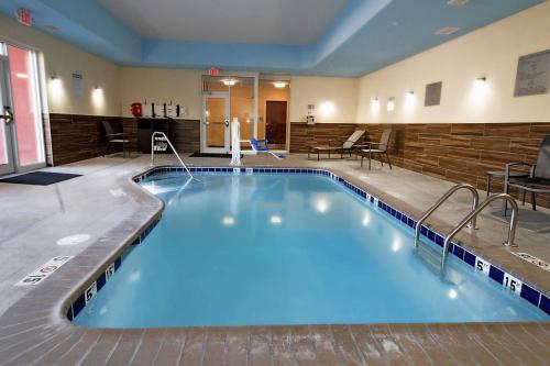 a large swimming pool in a hotel room at Fairfield Inn & Suites by Marriott London in London