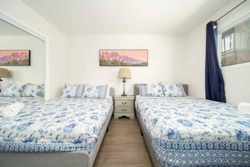 a bedroom with two beds with blue and white sheets at Comfy Homey 2BR Home near Hollywood DTLA in Los Angeles