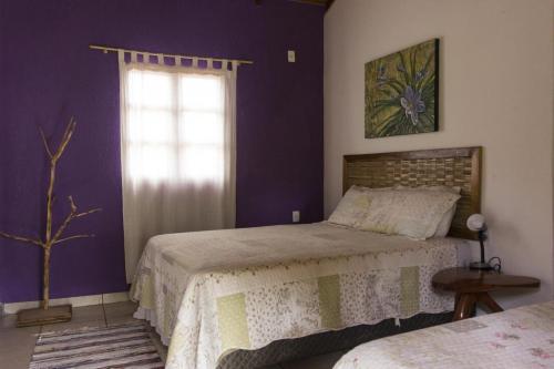a bedroom with two beds and a window at Pousada Luz do Sol in Sao Jorge