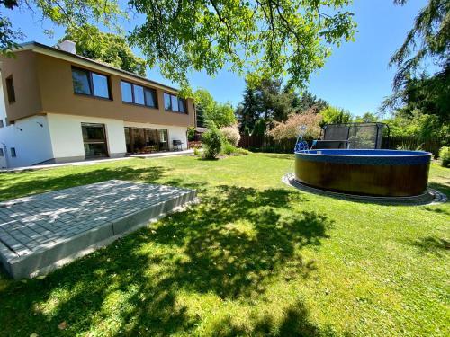 a house with a swimming pool in the yard at Residence Dymokury in Dymokury