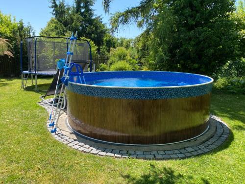 a large wooden tub sitting in the grass at Residence Dymokury in Dymokury