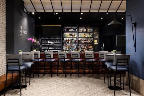 a bar in a restaurant with stools at SpringHill Suites by Marriott New York Manhattan/Times Square South in New York