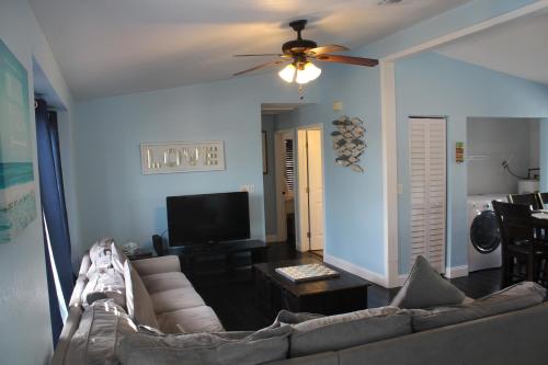 a living room with a couch and a flat screen tv at Tropical Cottages in Marathon