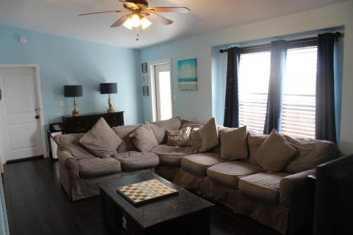 a living room with a couch and a ceiling fan at Tropical Cottages in Marathon