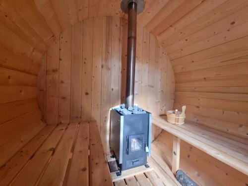 a sauna with a blue stove in a wooden room at Joó House in Balatonfüred