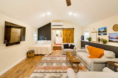 a living room with a bed and a couch at 20 Mi to Glacier Natl Park Columbia Falls Studio in Columbia Falls
