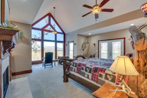 a bedroom with a bed and a ceiling fan at Blairsville Mansion with Hot Tub, Casino and Games! in Blairsville