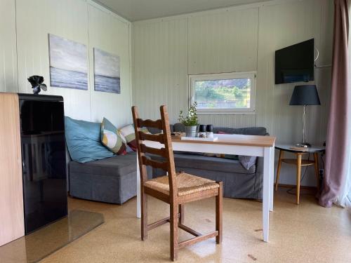 a living room with a table and a chair and a couch at Hausboot im Hafen in Sankt Goar