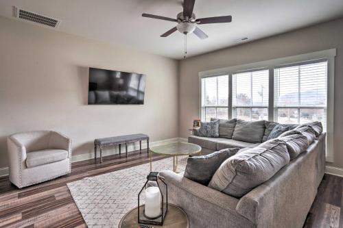 a living room with a couch and a ceiling fan at Wooded Escape with Beautiful Backyard and Mtn Views! in Chattanooga