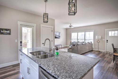 a kitchen with a sink and a living room at Wooded Escape with Beautiful Backyard and Mtn Views! in Chattanooga
