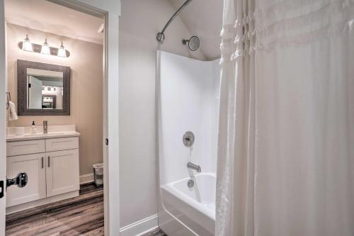 a white bathroom with a shower and a sink at Wooded Escape with Beautiful Backyard and Mtn Views! in Chattanooga