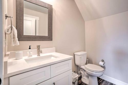a white bathroom with a sink and a toilet at Wooded Escape with Beautiful Backyard and Mtn Views! in Chattanooga