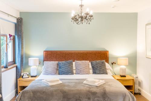 a bedroom with a large bed with towels on it at The Gower Hotel in Swansea