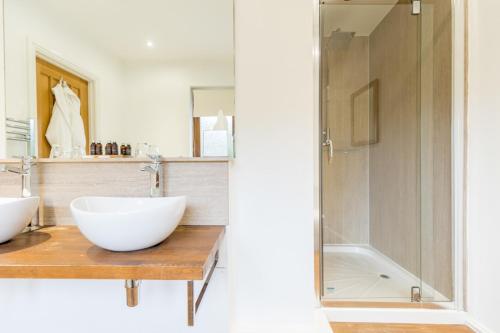 a bathroom with a sink and a shower at The Gower Hotel in Swansea