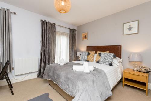 a bedroom with a large bed and a window at The Gower Hotel in Swansea