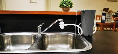 a kitchen sink with a faucet on a counter at StayInn Gateway Hotel Apartment, 2-bedroom Kuching City PrivateHome in Kuching