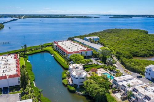an aerial view of a resort with a boat in the water at Sunbow Bay 108 condo in Holmes Beach