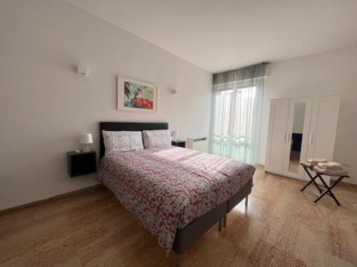 a bedroom with a large bed and a window at Appartamento Barbieri in Bologna
