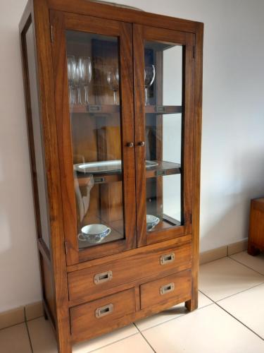 a wooden cabinet with glass doors in a room at Apartaments Bell-Lloc Puigcerda in Puigcerdà
