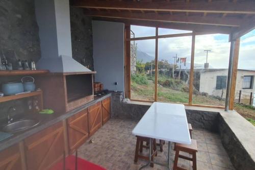 a kitchen with a white table and a sink at Haven of Serenity in São Vicente