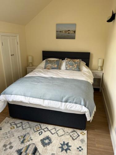 a bedroom with a large bed with two pillows at The Loft, Steep, Petersfield in Collyers Estate part of The South Downs National Park. in Petersfield