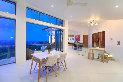 an open living room with a table and chairs at Villa Pearl - Amazing View in Amphoe Koh Samui