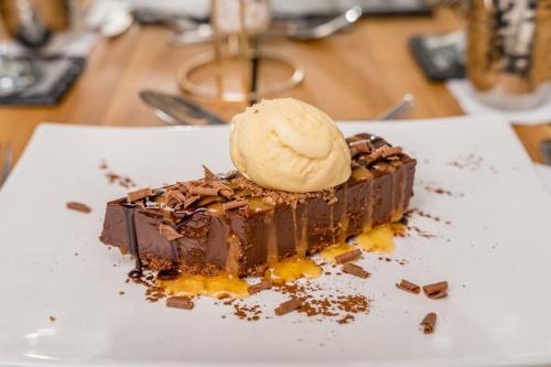 a chocolate dessert with a scoop of ice cream on top at The Gower Hotel in Swansea