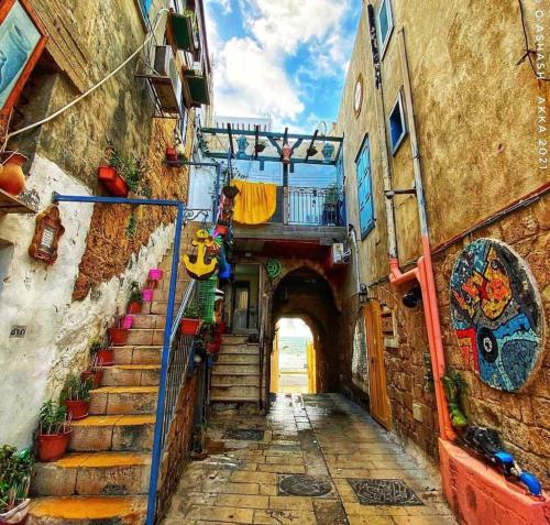 an alley with stairs and a tunnel in a city at LUXURY HOUSE AKKO in ‘Akko