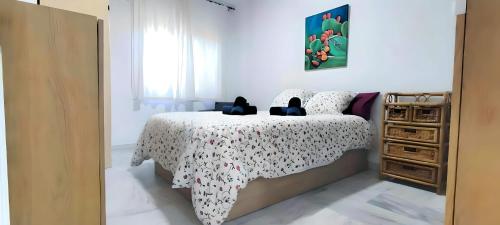 a bedroom with a bed and a dresser at Laguna Green Apartment in Torrox Costa