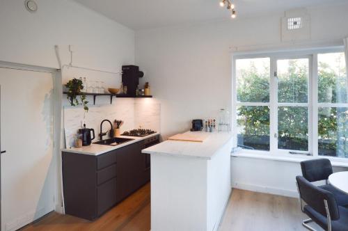 a kitchen with a counter and a sink and a window at Boutique Appartement Oost in Nijmegen
