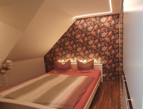 a bedroom with a bed and a wall with flowers at Appartementwohnung Central Bad Sachsa in Bad Sachsa