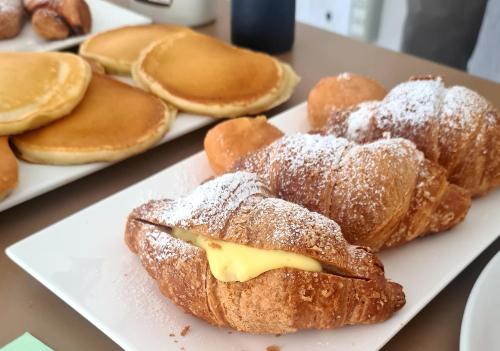 a plate of pastries with powdered sugar on them at Hotel Camelia in Rimini