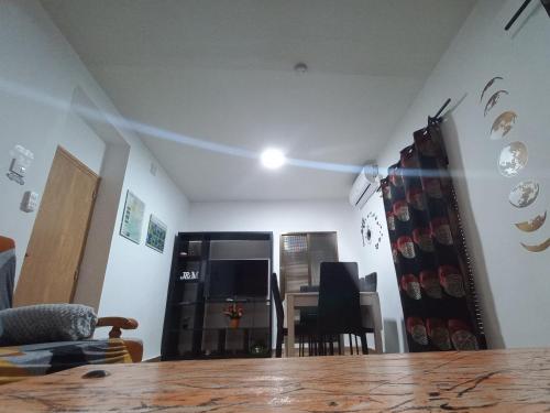 a living room with a table and a light on the ceiling at La Casita de Martina in Sotillo de la Adrada