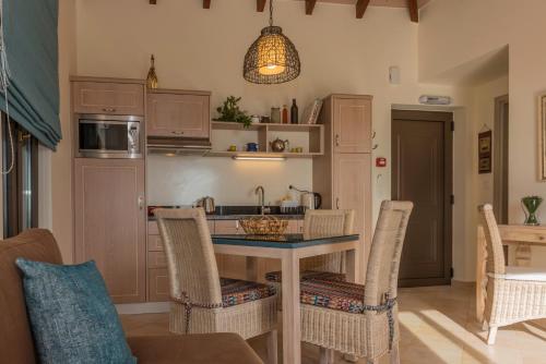 a kitchen with a table with chairs and a sink at Christos Place-Anidri in Palaiochóra