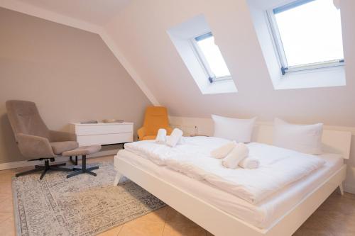 a bedroom with a bed with two stuffed animals on it at Ferienwohnung Lee Ost 2 4 in Dierhagen