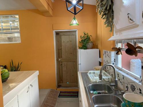 a kitchen with a sink and a refrigerator at Story Villa 2 Bedrooms with Mountain & Ocean View in Canaries