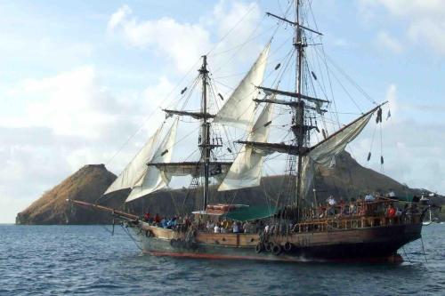 a tall ship with people on it in the ocean at Story Villa 2 Bedrooms with Mountain & Ocean View in Canaries