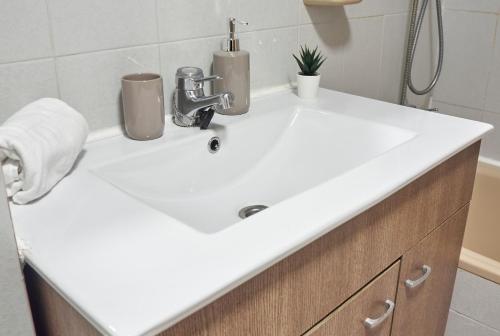 a bathroom sink with a white counter top at COSTA AZUL in Puerto de Sagunto