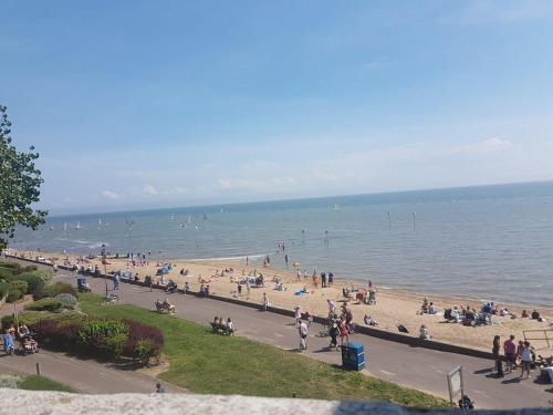 a group of people on a beach near the water at Leigh-on-Sea Retreat - 2 Bedroom Apartment in Leigh-on-Sea