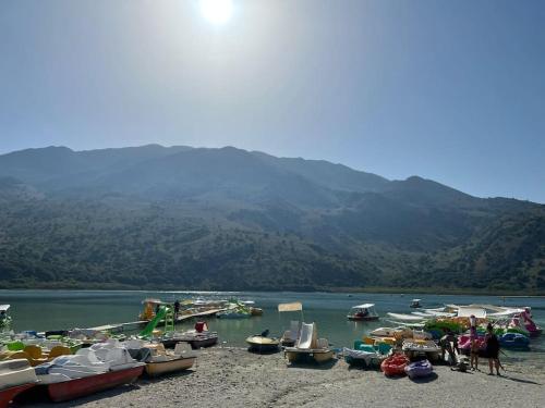 a group of boats on the shore of a lake at Carlas House, Kalyves in Tsivarás
