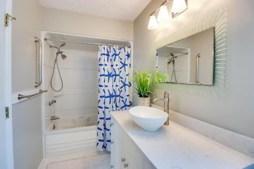 a white bathroom with a sink and a shower at Beachy Maryland A-Frame Steps to Chesapeake Bay! in Ridge