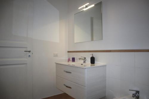 a white bathroom with a sink and a mirror at Villa Gagliozzi in Ercolano