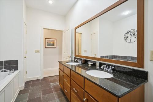 a bathroom with two sinks and a large mirror at Gorgeous views, tastefully decorated Ski on ski off 3 bedroom condo, with sports center access Lodges 303 in Killington