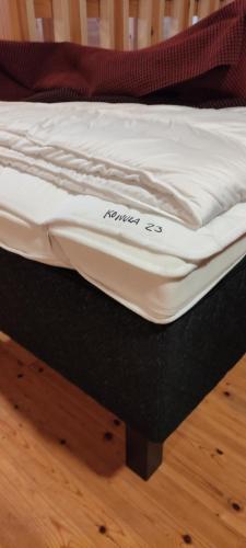 a mattress on a bed frame on a wooden floor at Himos, Areenan alue in Jämsä