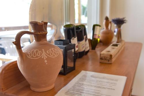 a vase sitting on top of a wooden table at Borács Winedégház in Bogács